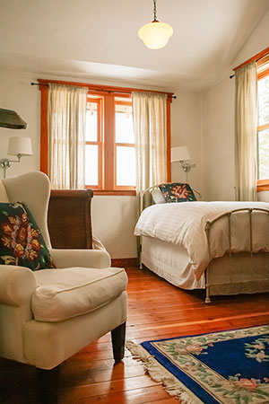 Meadow House farm stay vacation rental bedroom with three twin beds