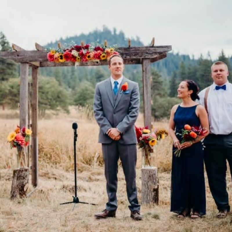 wedding groom eagerly awaits his bride at the altar for outdoor wedding at the ranch