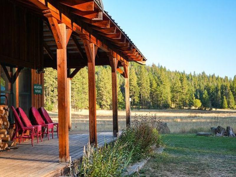 Meadow House wrap-around porch with meadow and forest view