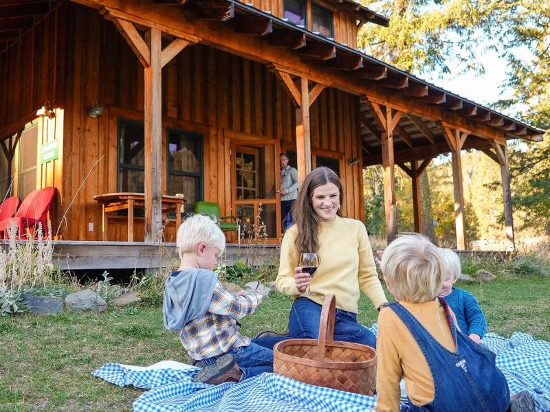 mother and three boys on picnic blanket on Meadow House lawn