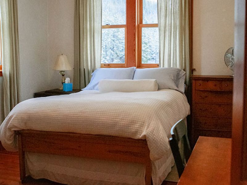east bedroom with queen bed and single sleeper sofa